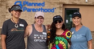 Lucy, Mayra, and other volunteers standing outside Planned Parenthood